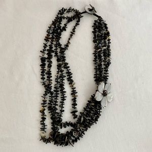 Beaded shell necklace with mother of pearl flower